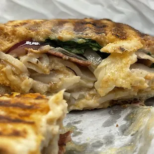 The turkey sandwich comes warmed w/Turkey bacon, red onions, spinach and a homemade sauce.