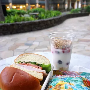 Turkey &amp; Swiss: oven roasted turkey, boar's head swiss cheese, tomato, arugula, dijon mayonnaise, brioche bun ($11). Yogurt Parfait ($7).