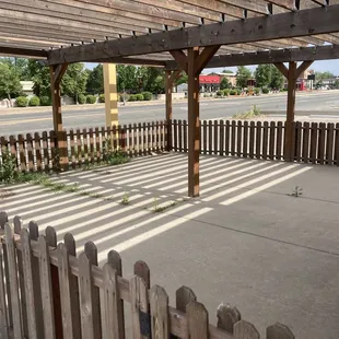 a covered area with a wooden fence