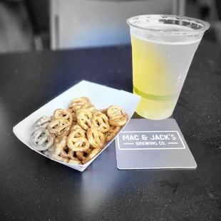 a plate of pretzels and a drink