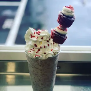 a milkshake with whipped cream and cupcakes