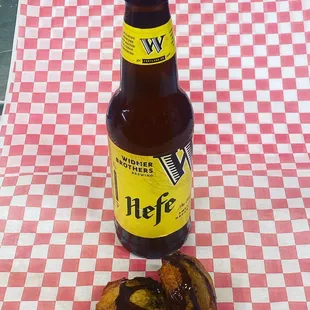 a bottle of hefe on a checkered tablecloth