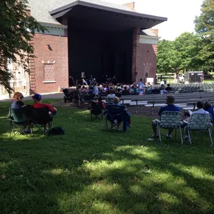 people sitting in lawn chairs