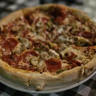 Pizza with pepperoni,  hamburger and green olives