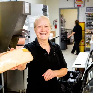 a woman holding a sandwich