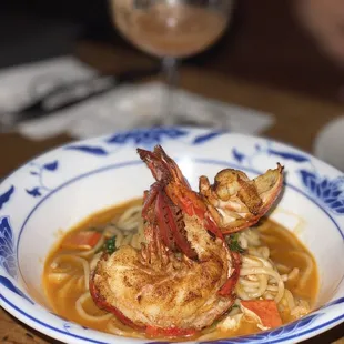 a bowl of shrimp and noodles
