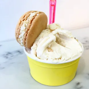 a cup of ice cream and a macaron