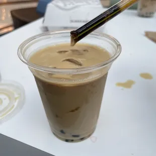 Pic of black milk tea with tapioca pearls clogging the straw lol.