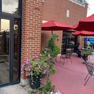 a patio with tables and umbrellas