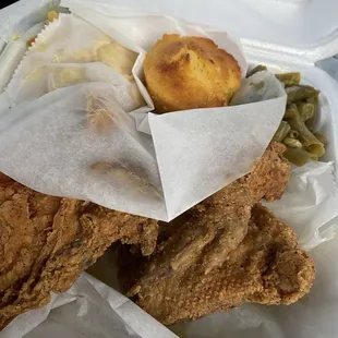 a fried chicken meal in a styrofoam container