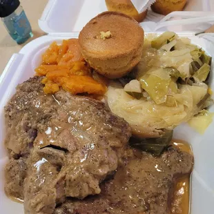 Smothered pork chops, cabbage, yams, cornbread