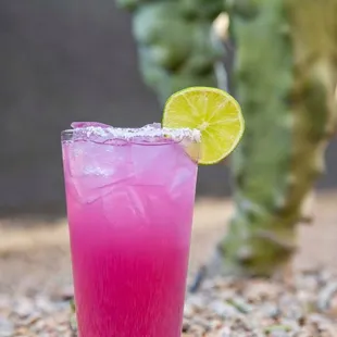 a pink drink with a lime slice