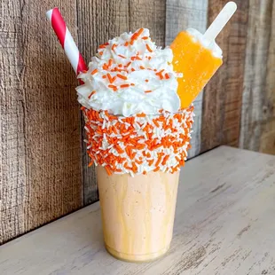 a milkshake with orange and white sprinkles