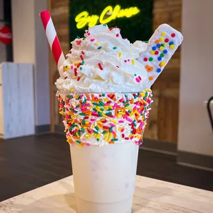 a milkshake with sprinkles and whipped cream