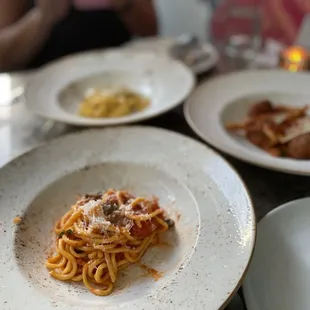 a plate of spaghetti and other dishes