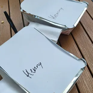 two open notebooks on a wooden table
