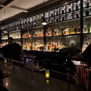 people sitting at a bar in a dimly lit room