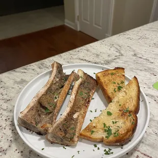 a plate of toasted bread on a marble countertop