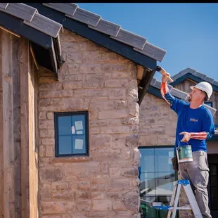 Extreme Makeover Home Edition Project. Jason Andrews painting the exterior