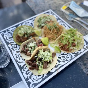 a plate of tacos and a glass of water