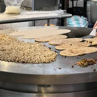 a person making tortillas