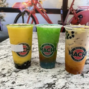 three different drinks on a table