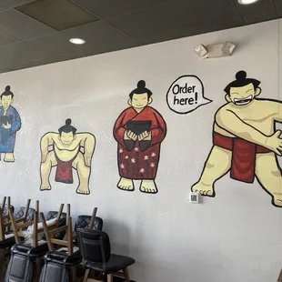 a variety of characters painted on a wall