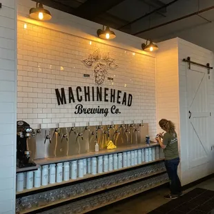 a woman standing in front of the machinehead