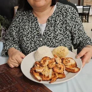 a woman holding a plate of food