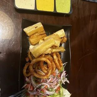 a plate of french fries and onion rings