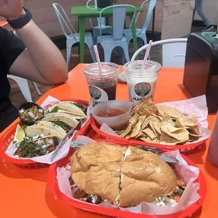 Torta de milanesa (asada), chips and salsa, tacos de al pastor, and horchata.