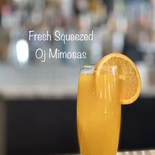 a glass of fresh squeezed oj mimosa