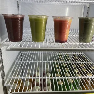 a variety of smoothies in a refrigerator