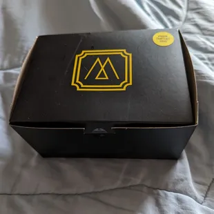 a black box with a yellow logo on it