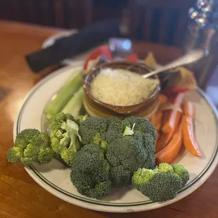 a plate of broccoli, carrots, and celery