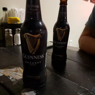 two bottles of guinness on a table