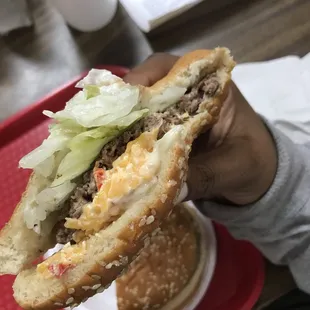 a person holding a sandwich