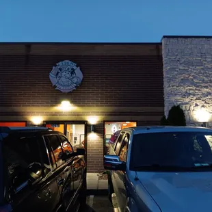 cars parked in front of a restaurant