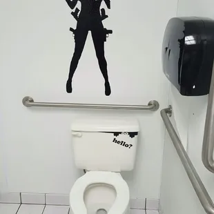 a woman with a gun on a toilet