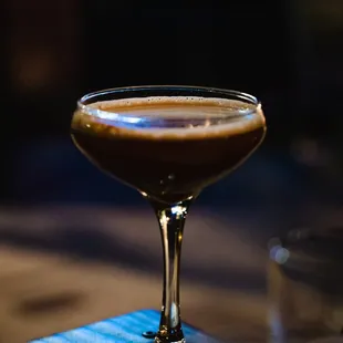 a drink in a glass on a table