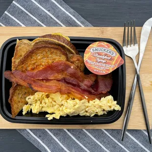 this platter comes with two half pieces of French toast, two slices of turkey bacon, and scrambled eggs. Served with breakfast syrup.