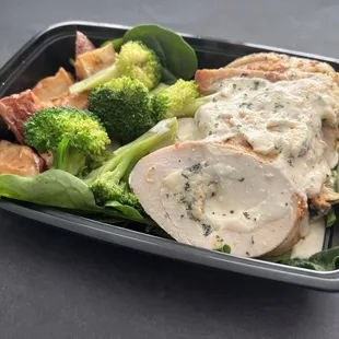 Turkey Spinach Stuffed Florentine. Made with turkey breast stuffed with creamy spinach and cheese. Served with a side of veggies.