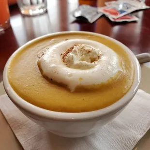 a bowl of soup with a donut on top