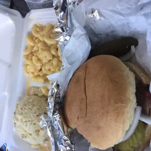 Brisket sandwich with potato salad and Mac and cheese