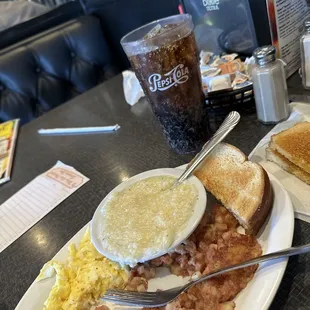 a plate of eggs, hash browns, toast, and toast