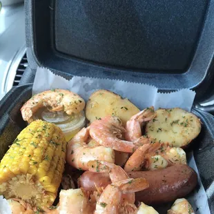 Shrimp box. (Shrimp, sausage, red potatoes, corn, and a cup of butter)