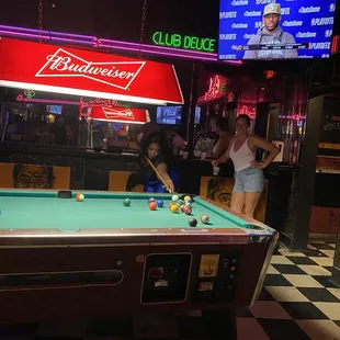 a woman playing pool