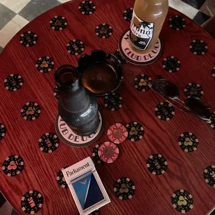 a table with a drink and sunglasses