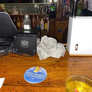 a drink and a laptop on a bar