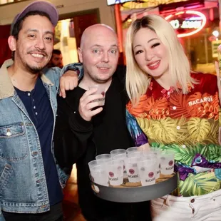 a man and two women holding drinks